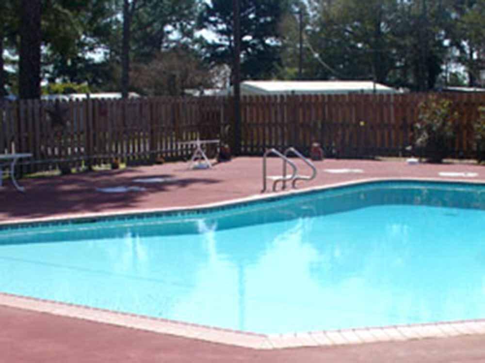 The fenced in swimming pool at THE PINES MH AND RV COMMUNITY