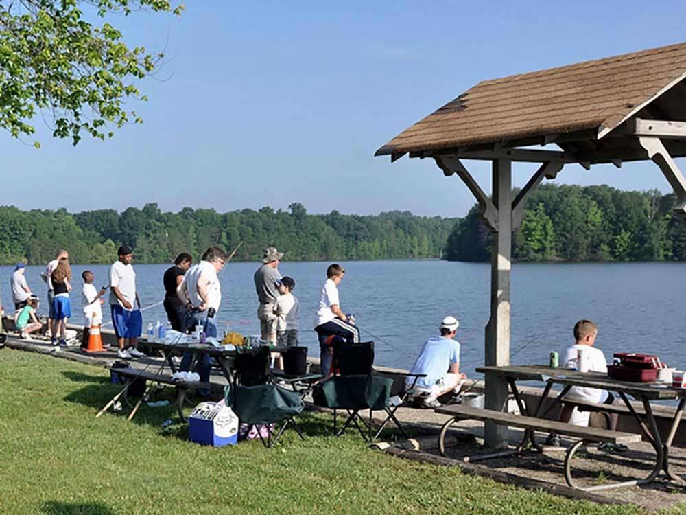 A line of people fishing at OAK HOLLOW FAMILY CAMPGROUND