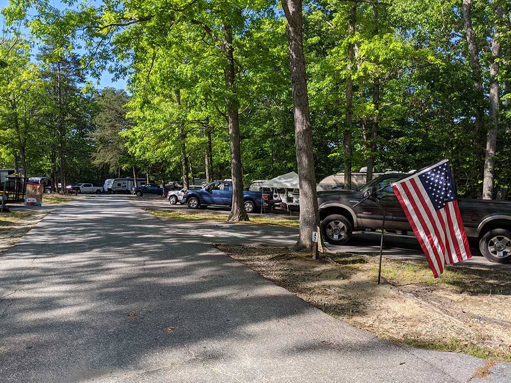 A line of RV sites under the trees at OAK HOLLOW FAMILY CAMPGROUND