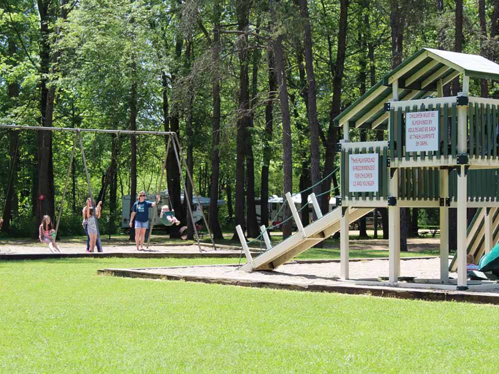 People playing on the playground equipment at APPLE CREEK CAMPGROUND & RV PARK