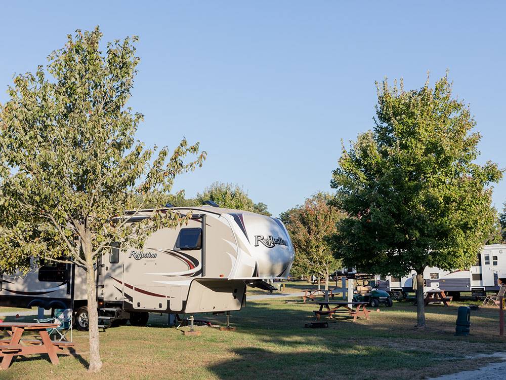 A fifth wheel trailer parked in a RV site at YOGI BEAR'S JELLYSTONE PARK AT DELAWARE BEACH