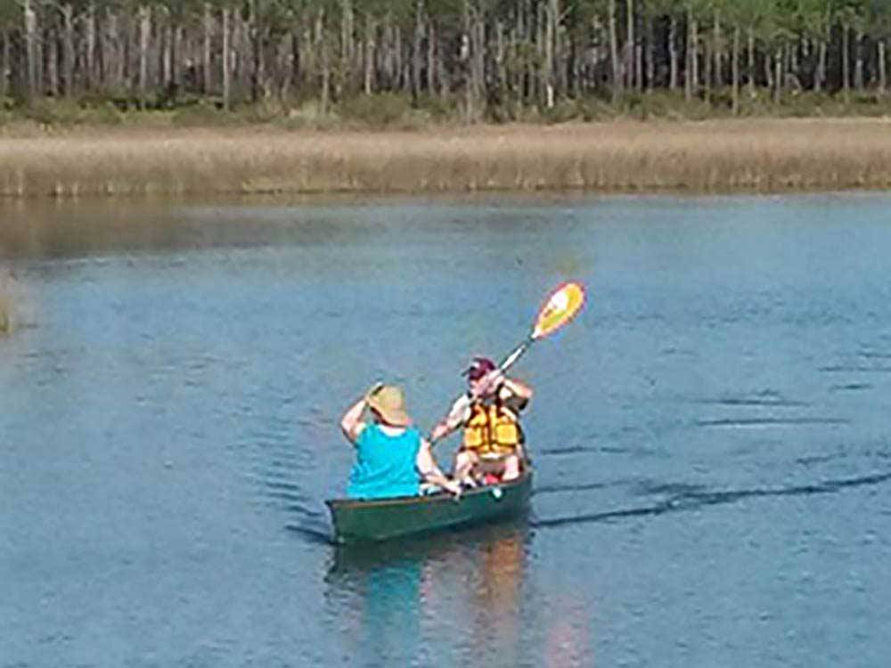 Two people in a canoe on the bayou at AVALON LANDING RV PARK