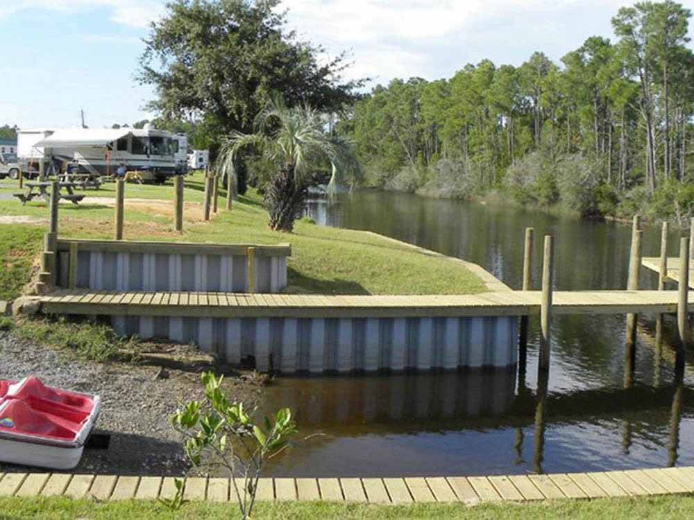 Paved sites with grassy area, picnic table, steps from the bay at AVALON LANDING RV PARK