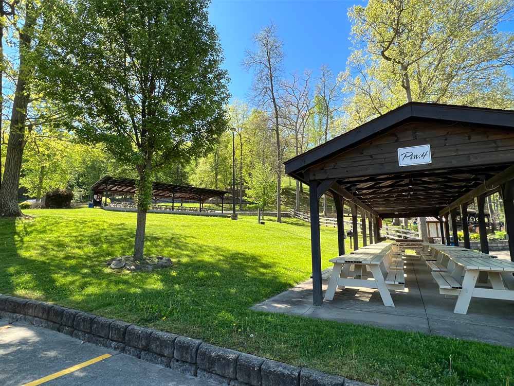 Picnic tables under a pavilion at WOOD'S TALL TIMBER RESORT