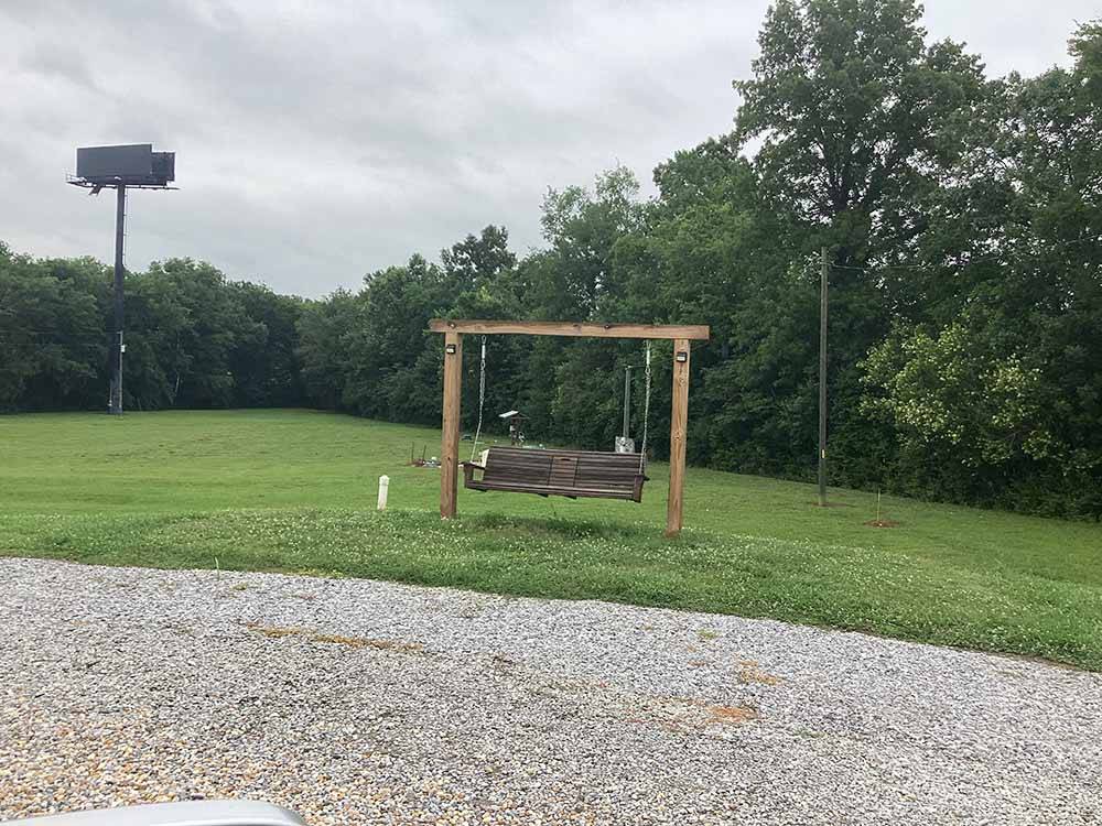 A swinging bench on a grassy area at MONTGOMERY SOUTH RV PARK & CABINS