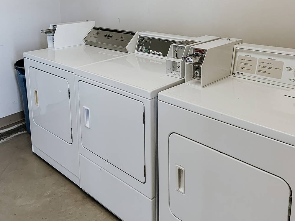 Dryers in a laundry room at Timbercrest Camp and RV Park