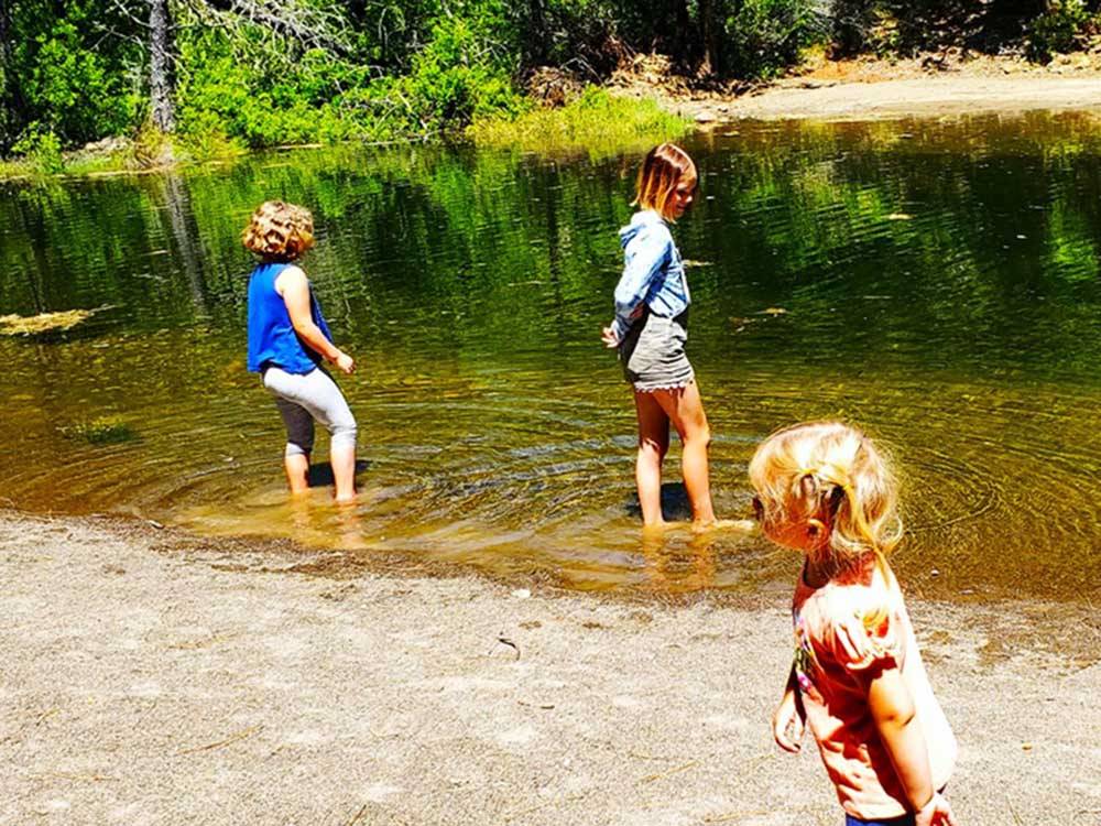 Three young girls playing in the river at LONE MOUNTAIN RESORT