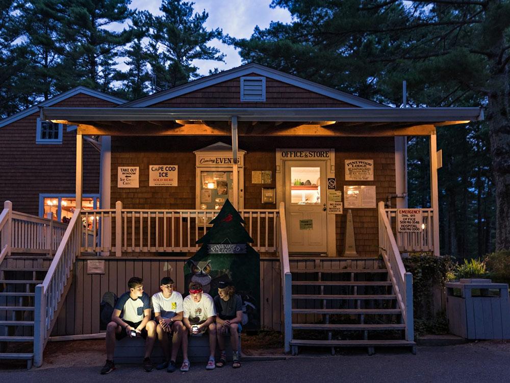 Family outside a rental cabin at PINEWOOD LODGE CAMPGROUND