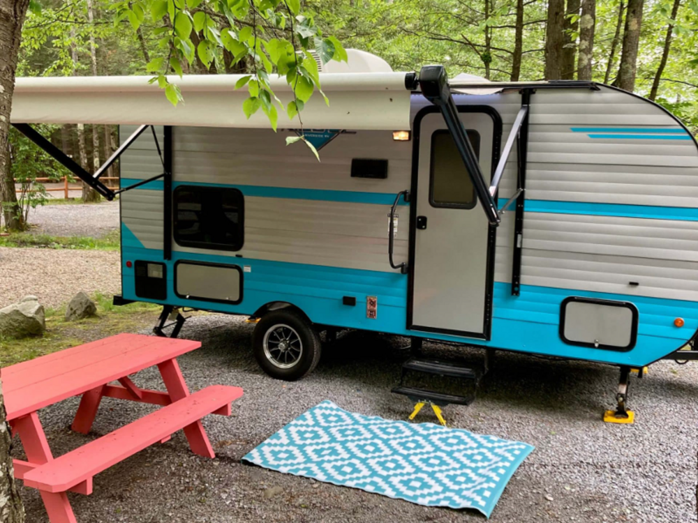 Camper with orange picnic table at Spacious Skies French Pond Campground