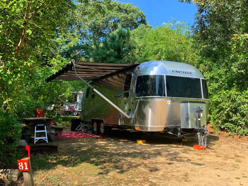 An Airstream in a dirt RV site at SHADY KNOLL CAMPGROUND