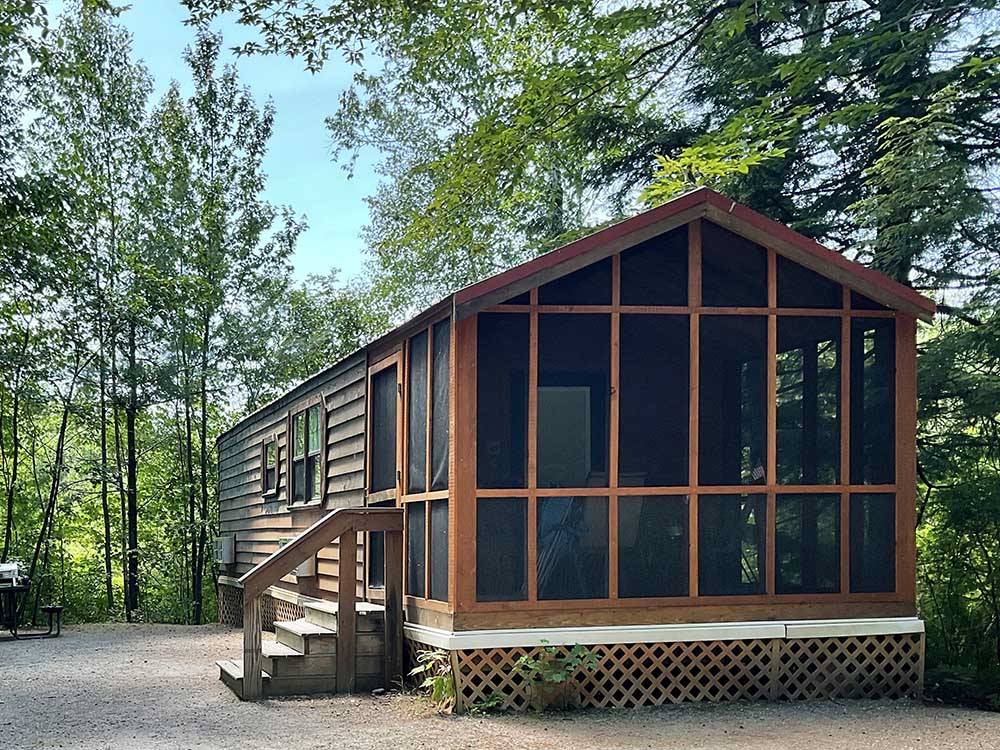 Large cabin surrounded by trees at CLEARWATER CAMPGROUND