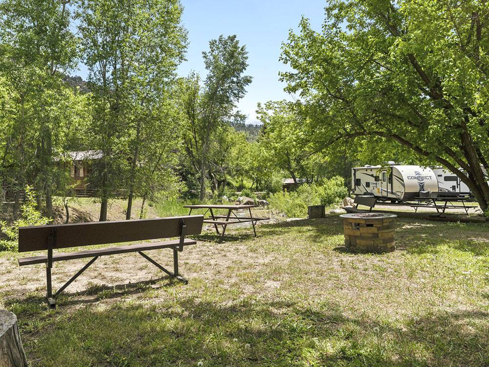 A shaded site with a fire pit