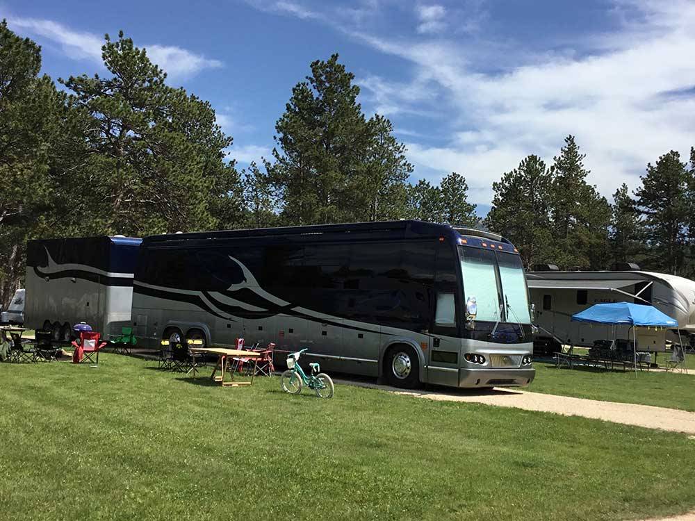 Big rig in site with large grass area at RAFTER J BAR RANCH CAMPING RESORT