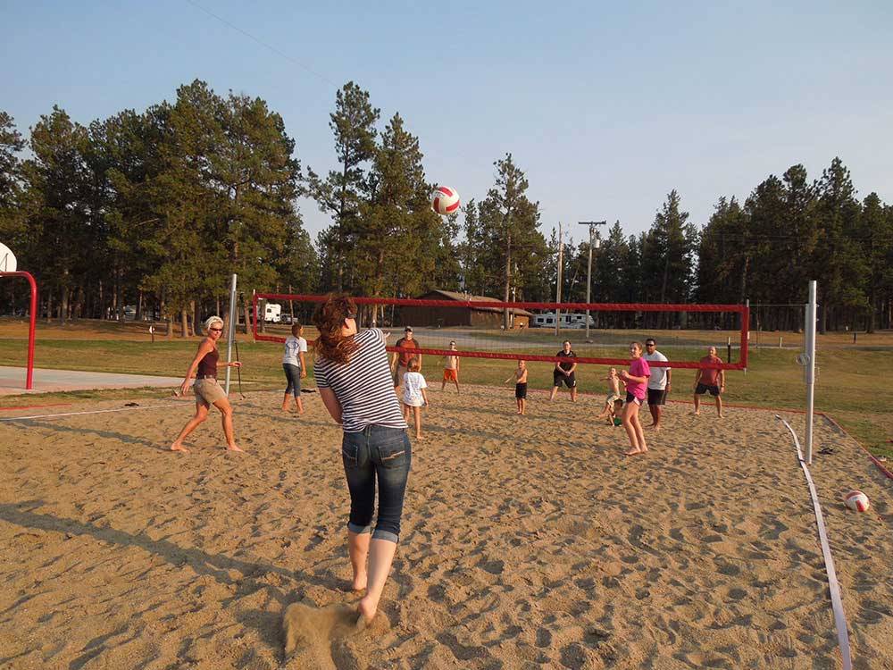 Campers playing volleyball at RAFTER J BAR RANCH CAMPING RESORT