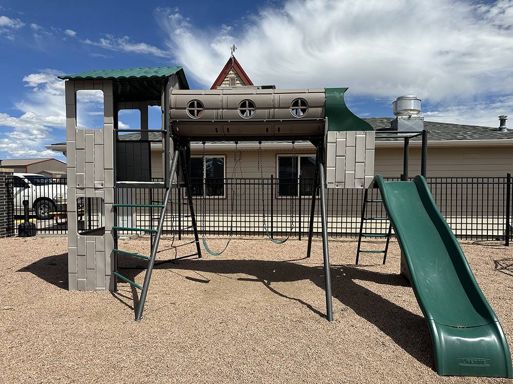 A swingset and slide at the playground