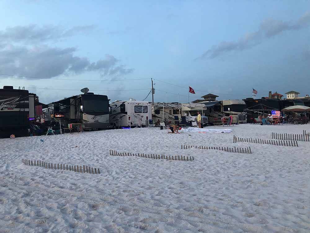 A line of motorhomes along the beach at CAMPING ON THE GULF