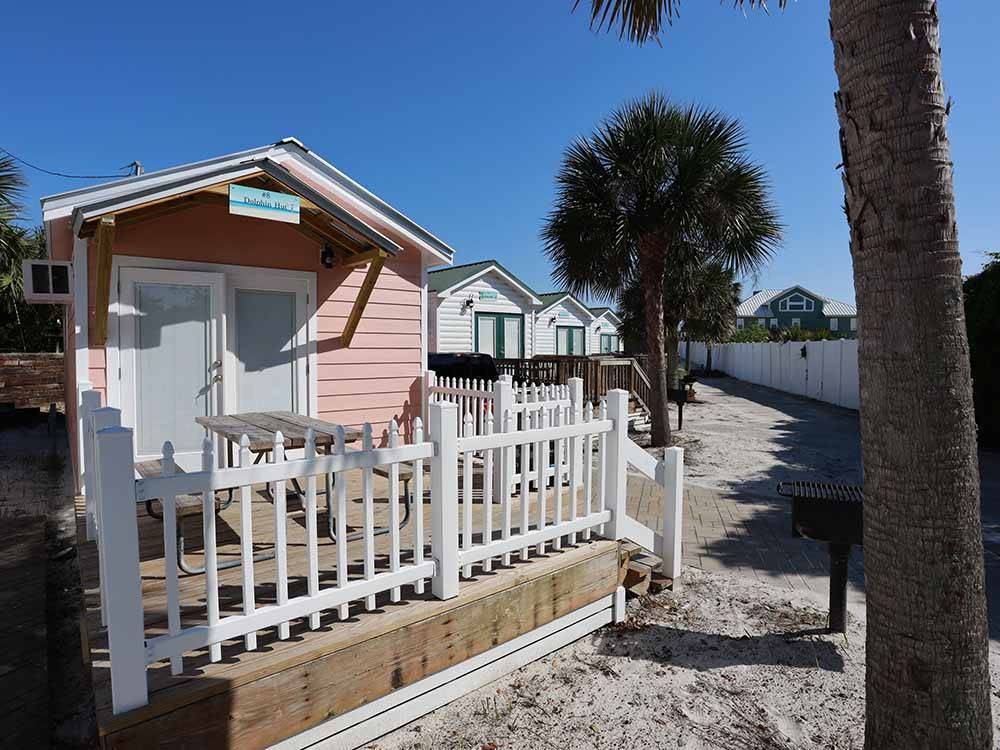 A row of colorful rental cabins at CAMPING ON THE GULF