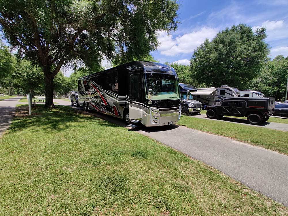 A motorhome in a pull thru RV site at TRAVELERS CAMPGROUND