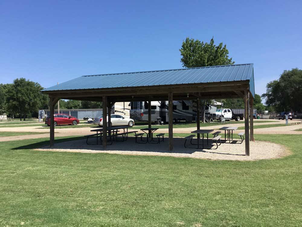 Patio area with picnic tables at COVERED WAGON RV RESORT