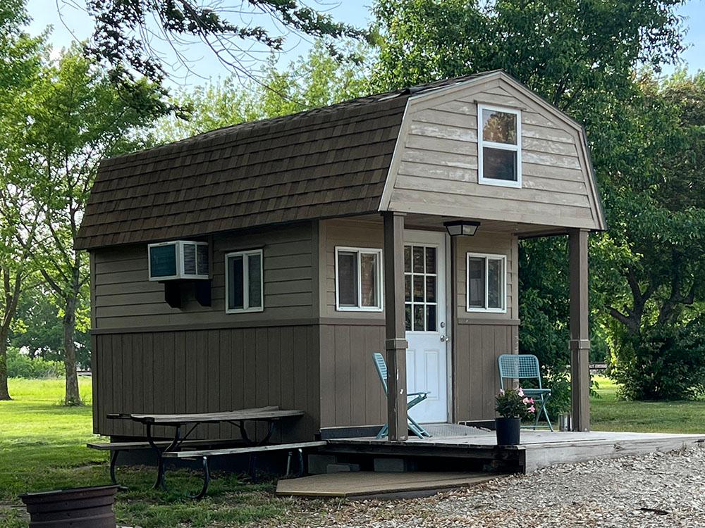 A rental cabin with porch, picnic table and fire ring