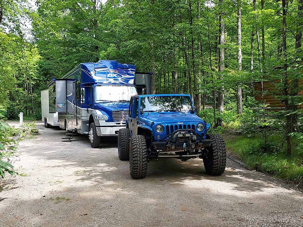 A Jeep and trailer in a deluxe pull thru site at HTR DOOR COUNTY