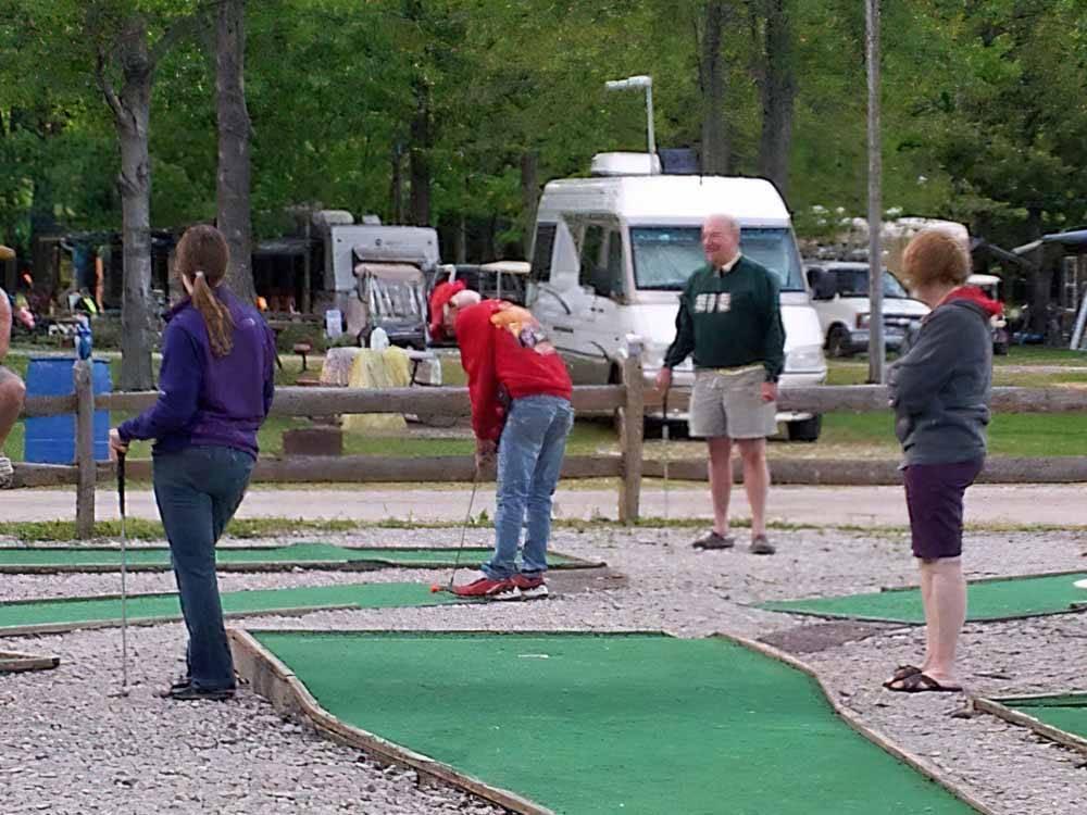 People playing miniature golf at EVERGREEN LAKE PARK