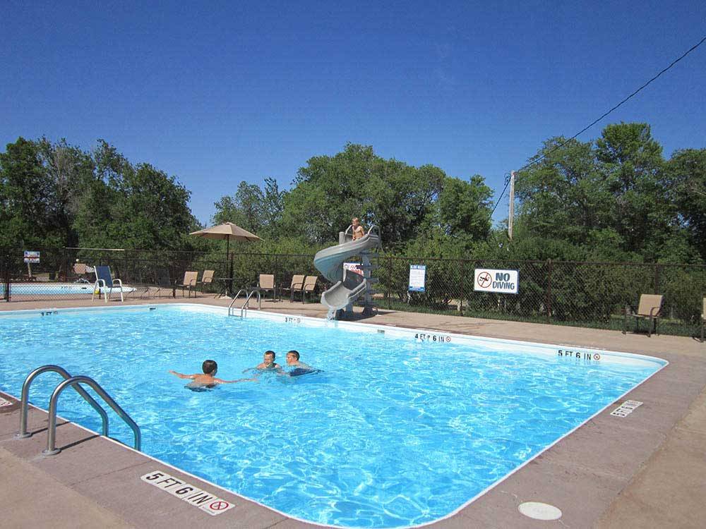 Kids swimming in pool at CHRIS' CAMP & RV PARK