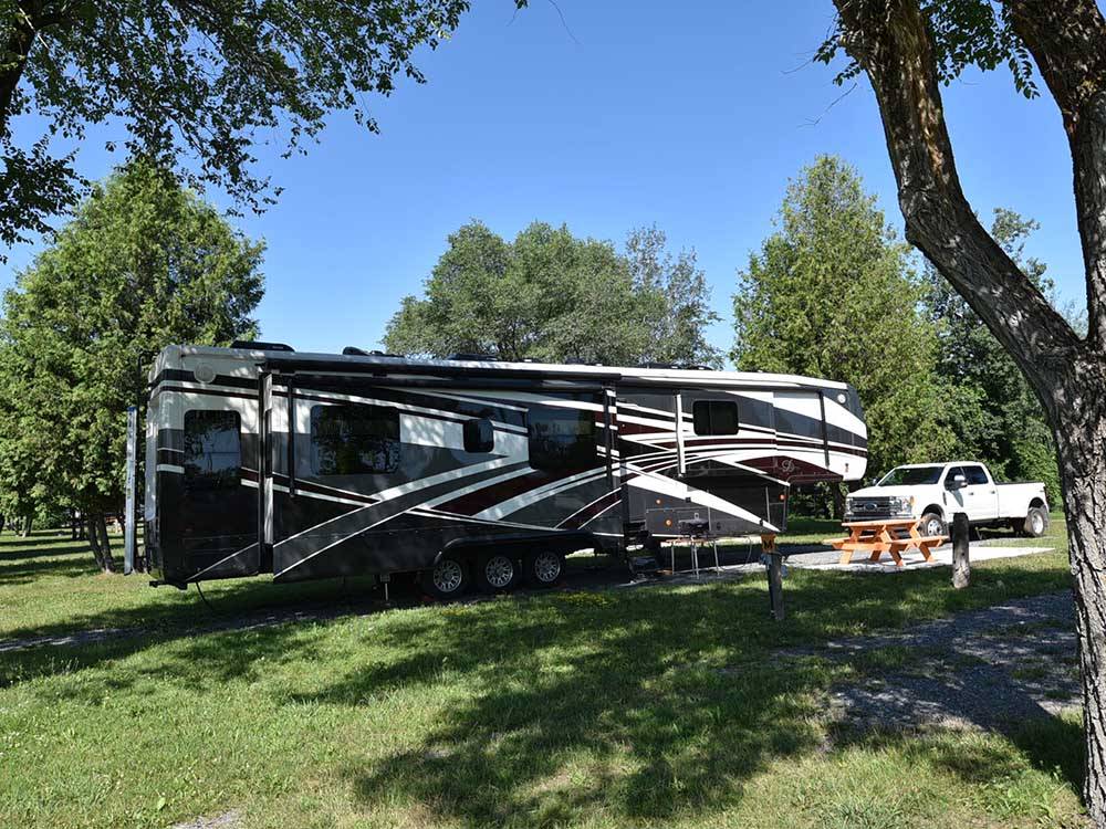 A large fifth wheel trailer in an RV site at CAMP HITHER HILLS