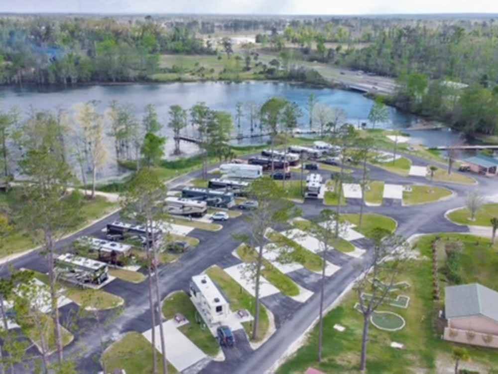 An aerial view of the paved RV sites and lake at FLORIDA CAVERNS RV RESORT AT MERRITT'S MILL POND