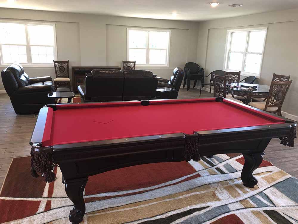 A red pool table and sitting area at FLORIDA CAVERNS RV RESORT AT MERRITT'S MILL POND
