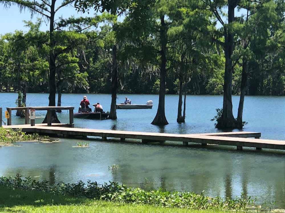 People fishing from boats at FLORIDA CAVERNS RV RESORT AT MERRITT'S MILL POND