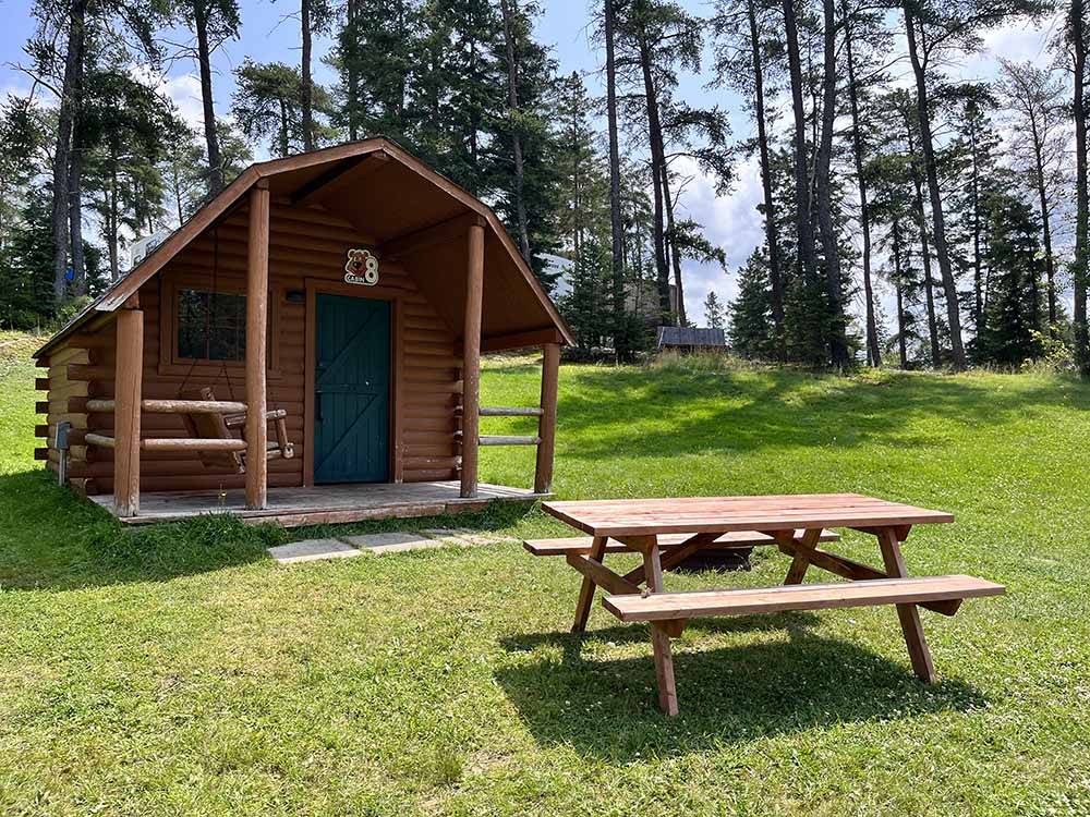 A cabin with a bench at THREE BEARS FAMILY CAMPING & RV PARK
