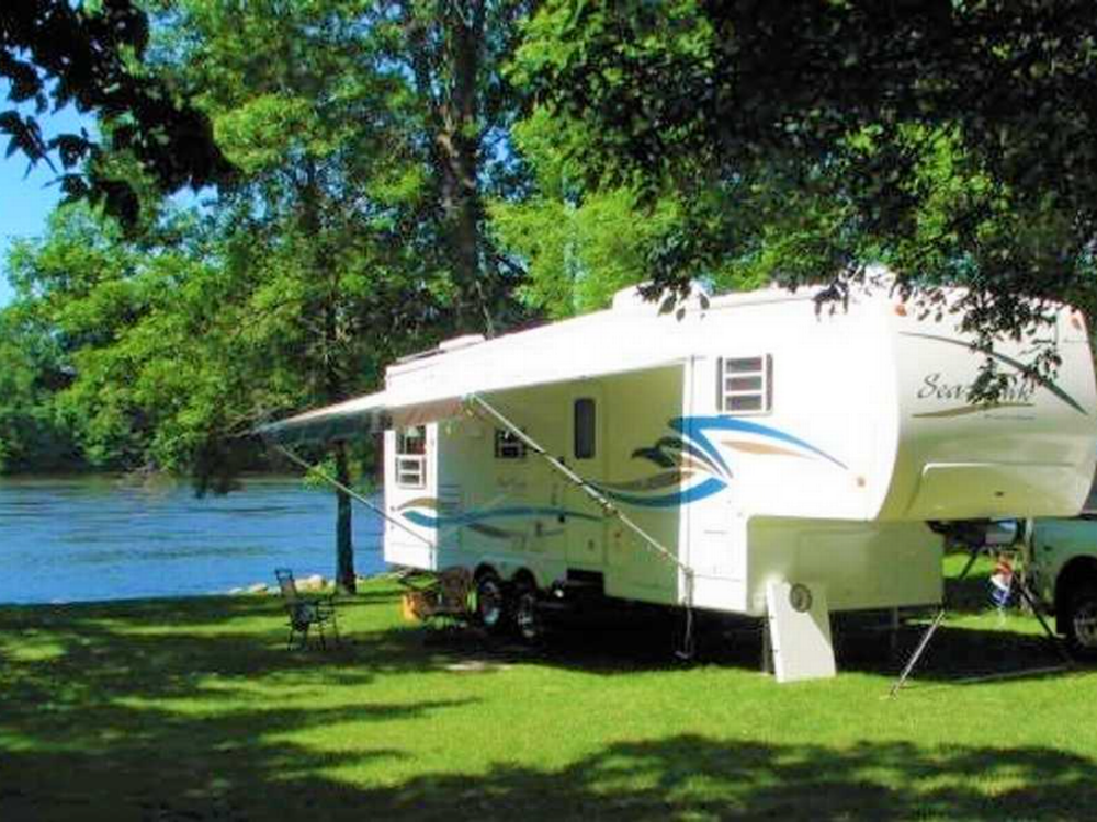 RV parked at site by the water