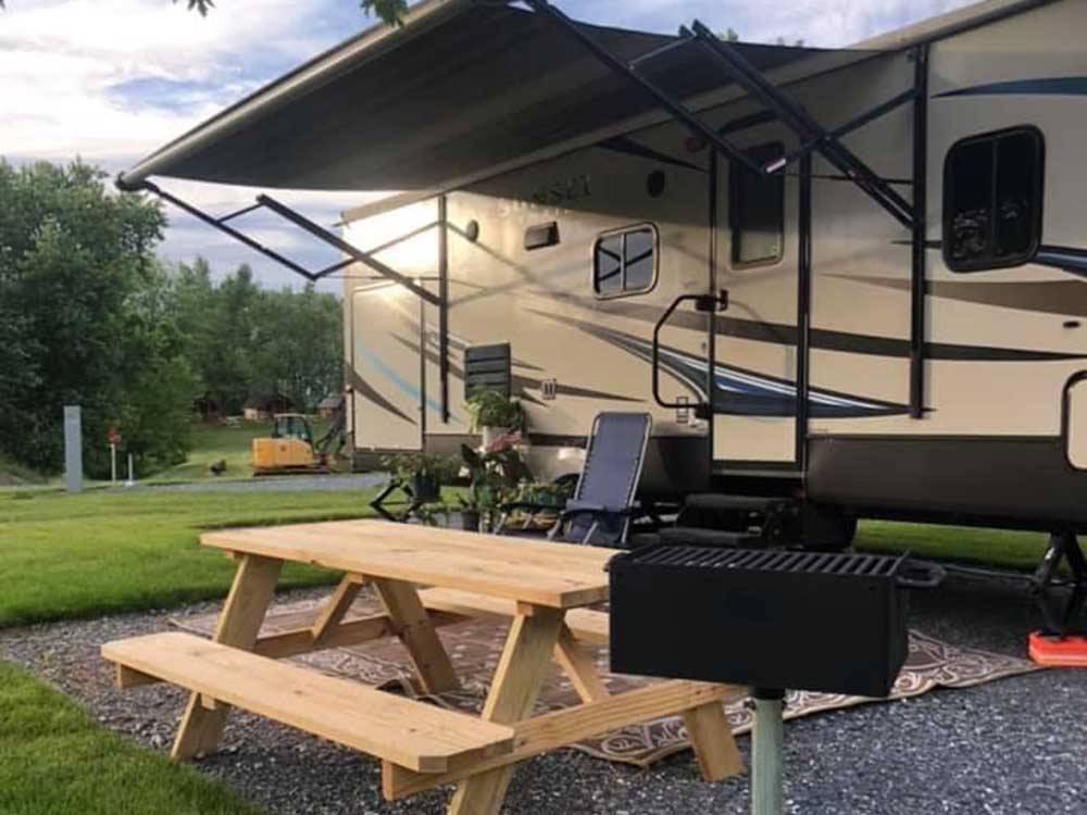 RV parked on-site near picnic table and grill at HERSHEY ROAD CAMPGROUND