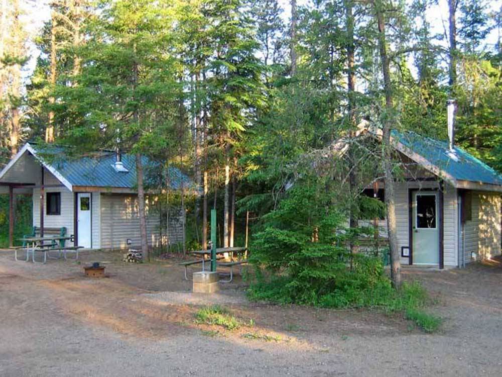A row of rustic rental cabins at HAPPY LAND RV PARK