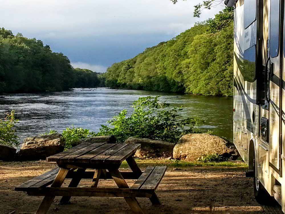 An RV site by the river at HIDDEN ACRES FAMILY CAMPGROUND