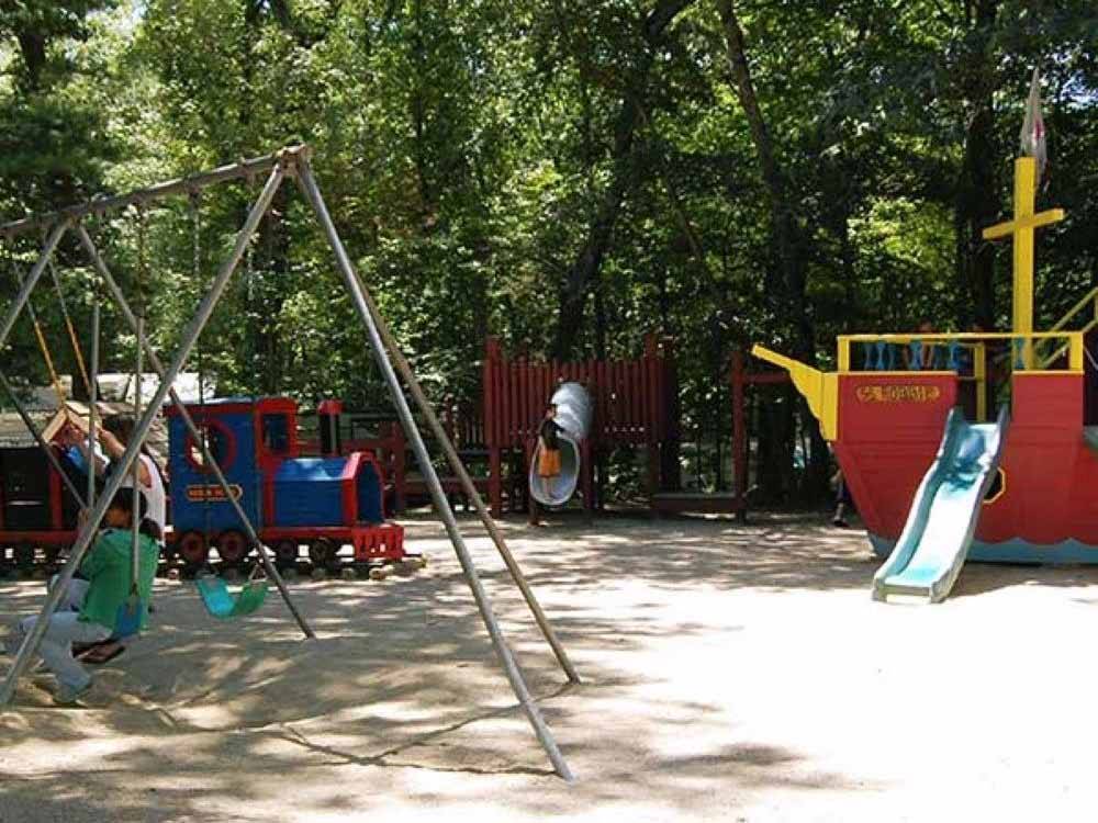 Some of the playground equipment at HIDDEN ACRES FAMILY CAMPGROUND