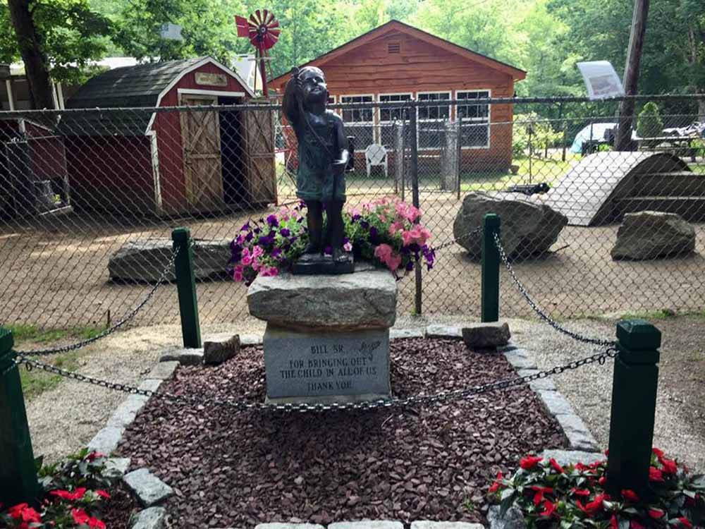 A statue of a little boy at HIDDEN ACRES FAMILY CAMPGROUND