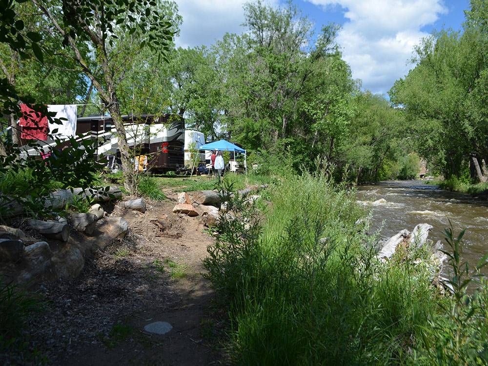 RVs parked next to the river at RIVERVIEW RV PARK & CAMPGROUND