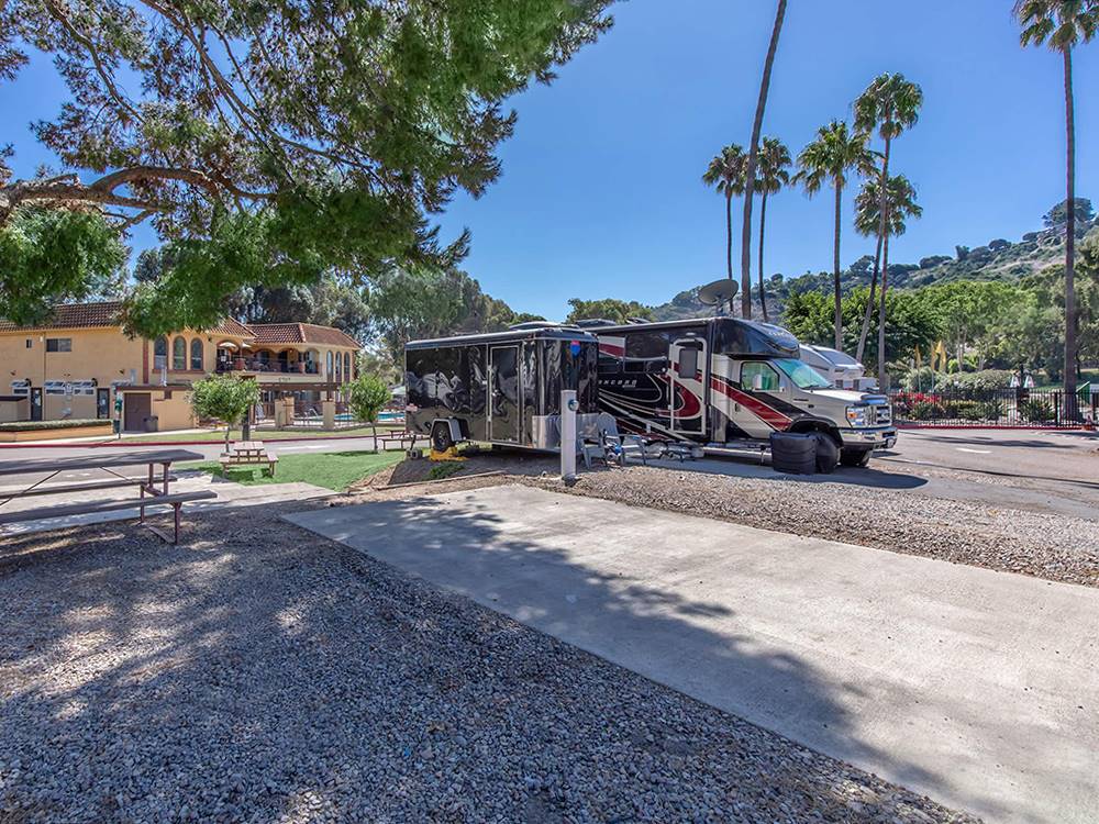 RV and trailer parked by a paved site