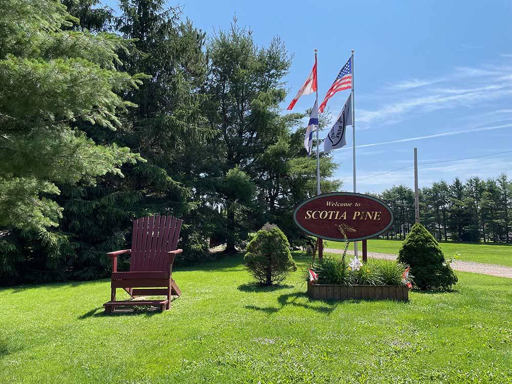 The front entrance sign with flags at SCOTIA PINE CAMPGROUND