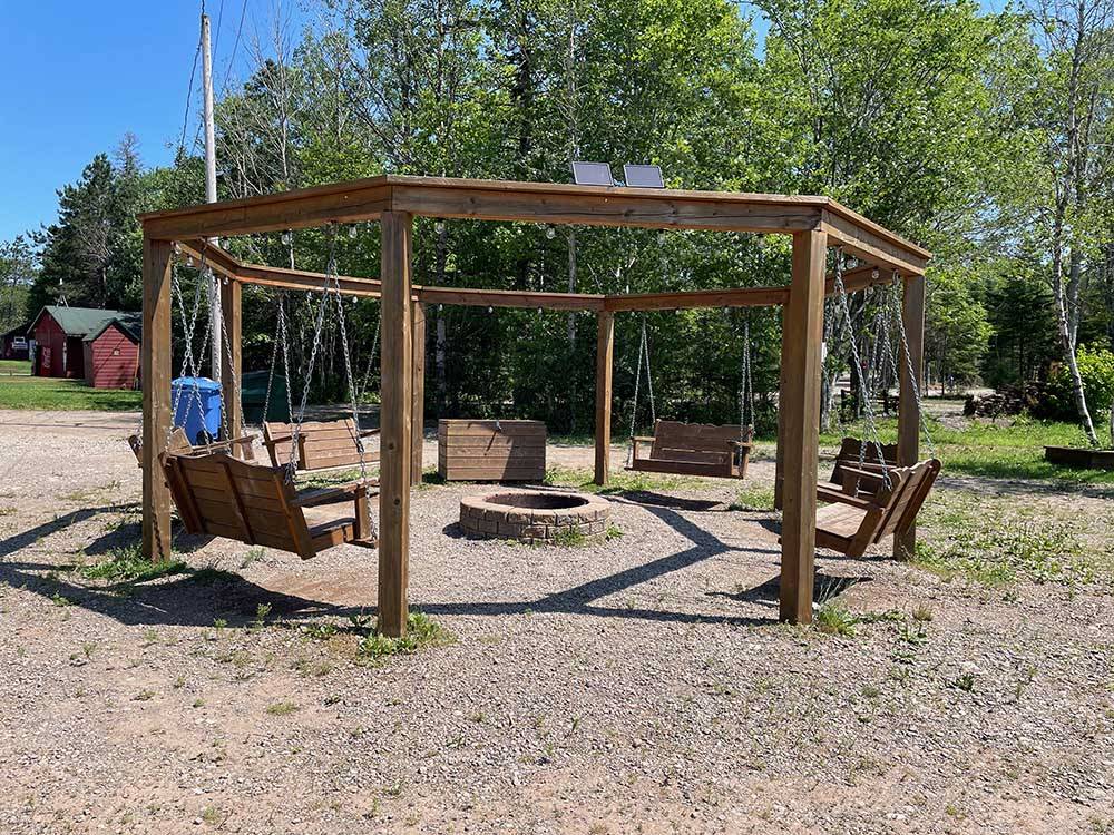 A circle of swinging benches and a fire pit at SCOTIA PINE CAMPGROUND