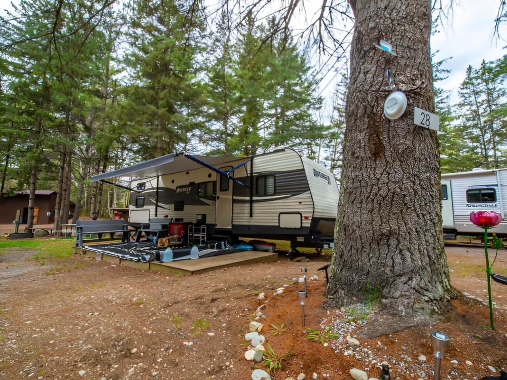 Parked trailer with patio at Spacious Skies Adirondack Peaks
