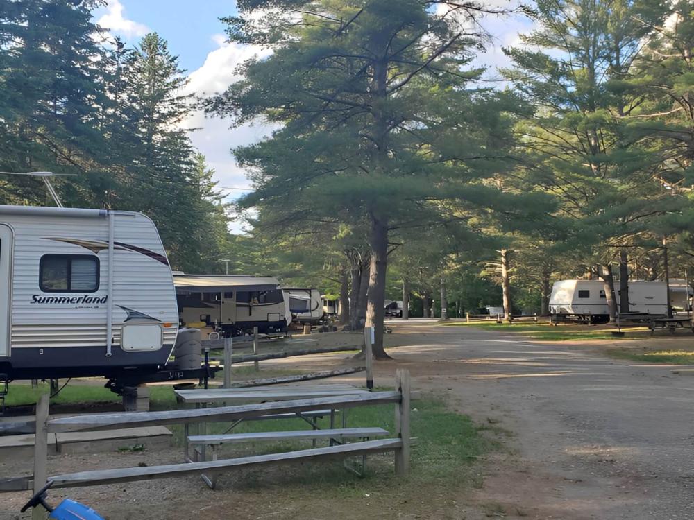 Parked trailers at site Spacious Skies Adirondack Peaks