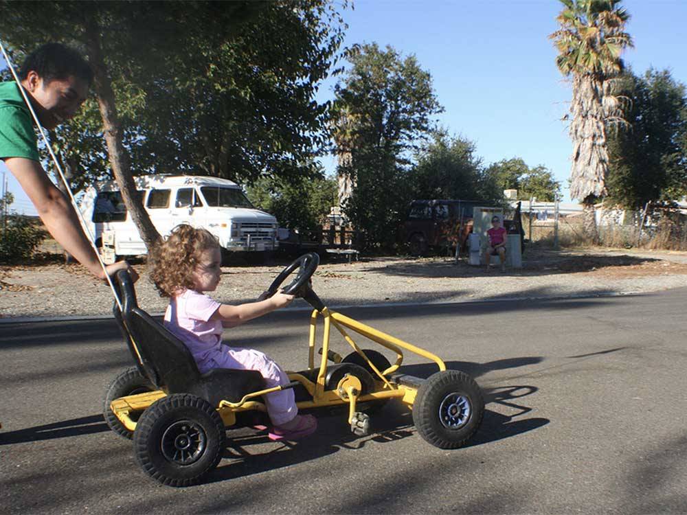 Girl riding a mini go-kart at SAC-WEST RV PARK AND CAMPGROUND