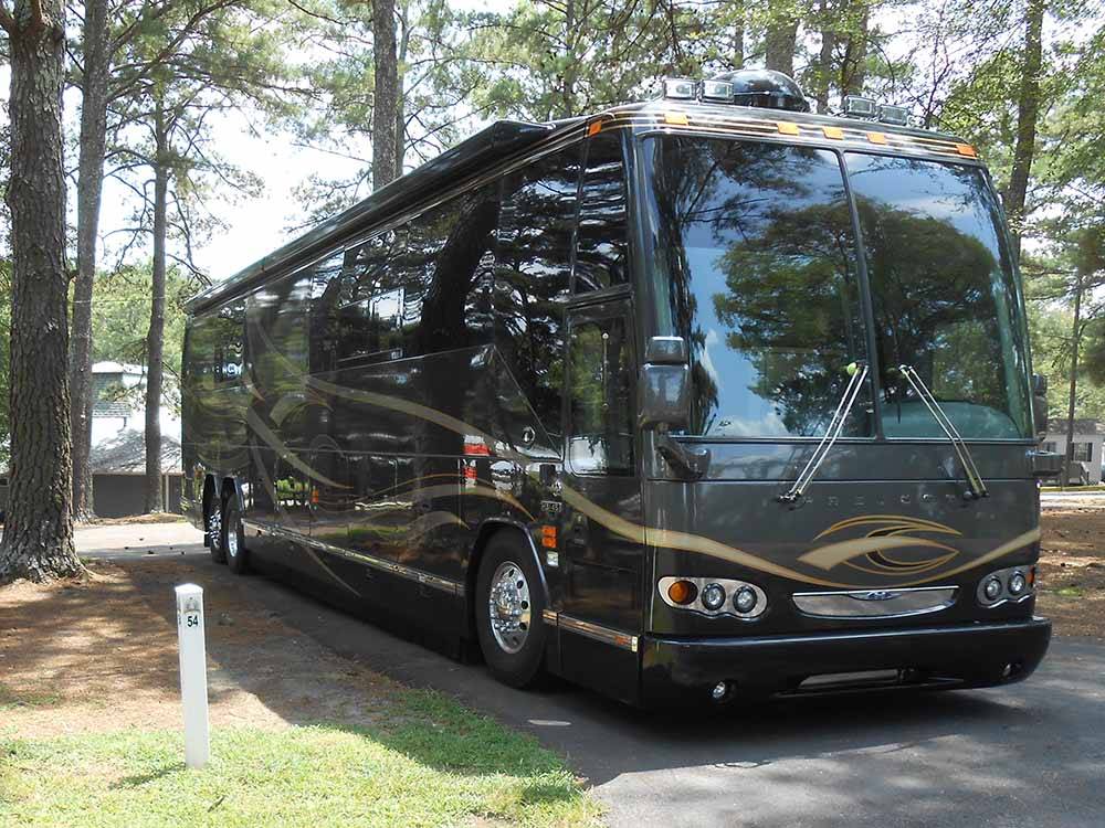 A motorhome in a paved back in RV site at ALLATOONA LANDING MARINE RESORT