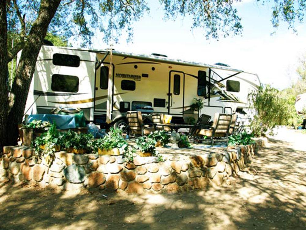 A fifth wheel in a RV site at WOODS VALLEY KAMPGROUND & RV PARK