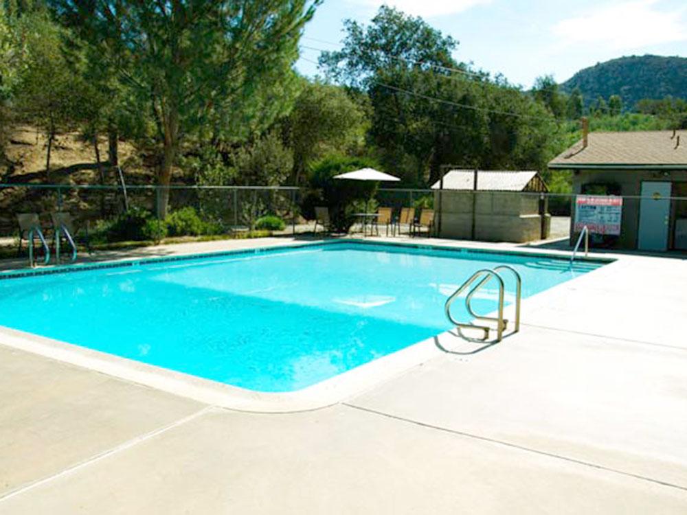 The fenced in swimming pool at WOODS VALLEY KAMPGROUND & RV PARK