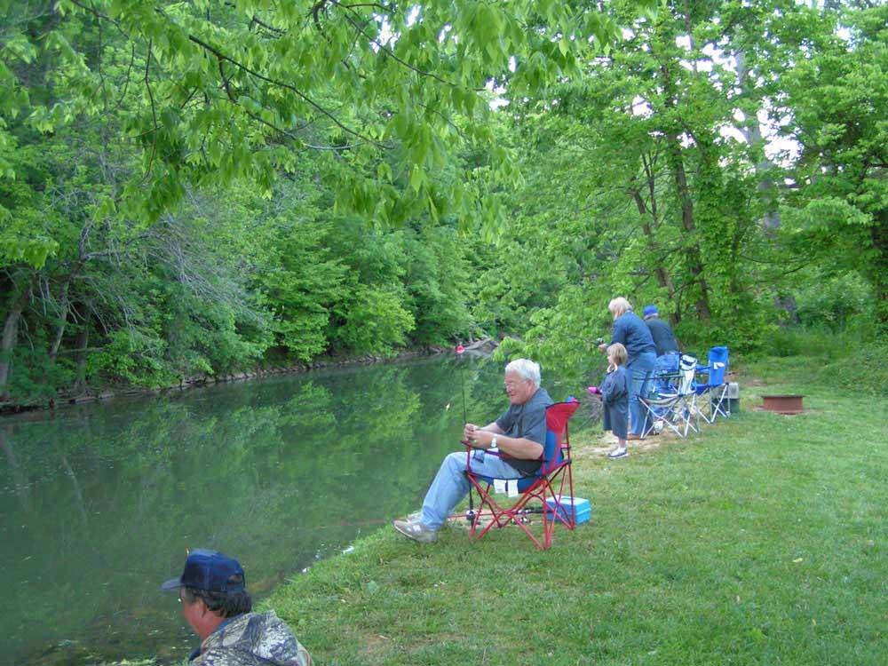 A group of people fishing on the river at ELKHORN CREEK RV PARK