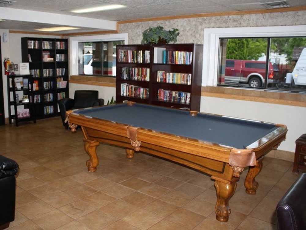 The pool table with bookshelves at MOUNTAIN SHADOWS RV PARK & MHP